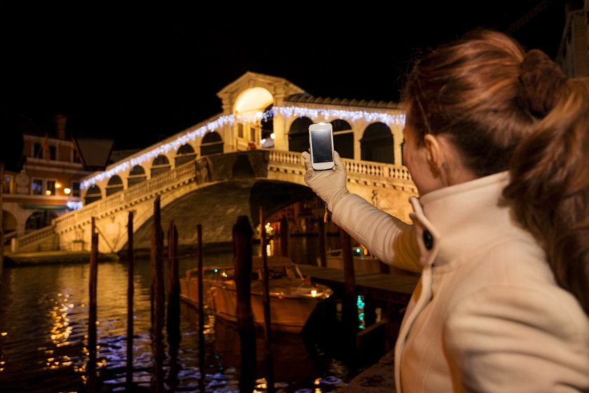 Woman Taking Photo Of Rialto Bridge In Christmas Venice, Italy
